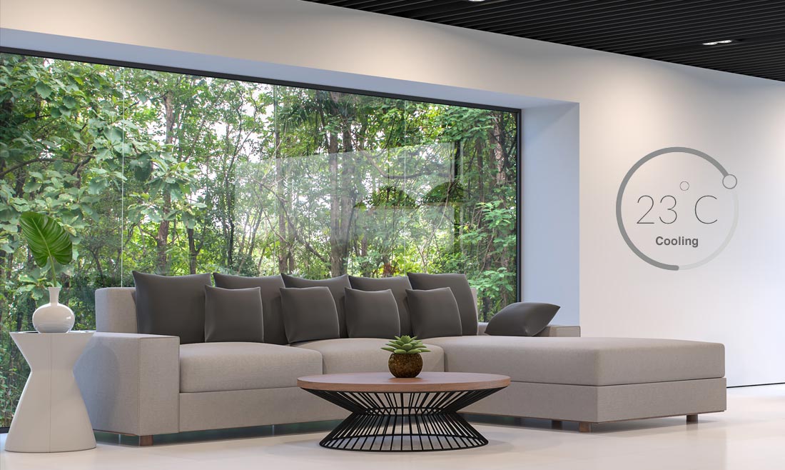 Interior of a modern house, with lush forest outside.